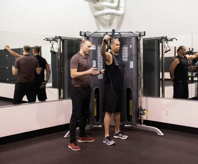Physiotherapist working with an athlete in the gym at Sherwood Park Acceleration Physiotherapy