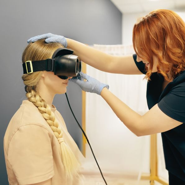 Woman with dizziness, vestibular rehab for vertigo, using infrared goggles. Acceleration Physiotherapy Sherwood Park