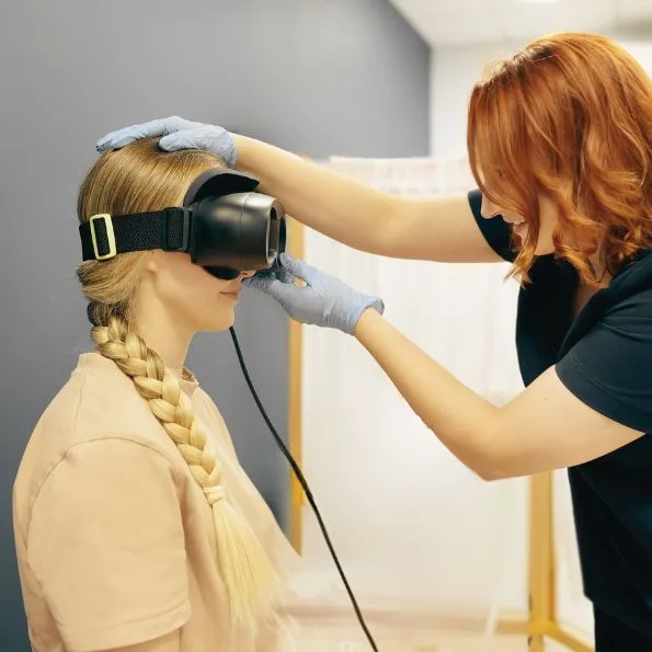 Woman with dizziness, vestibular rehab for vertigo, using infrared goggles. Acceleration Physiotherapy Sherwood Park